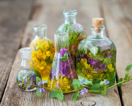 Bottles of tincture or infusion of healthy herbs on table. Herbal medicine.