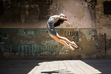 Fototapeta premium Young female dancer jumping
