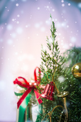 Christmas ball with bell on pine trees on snow background