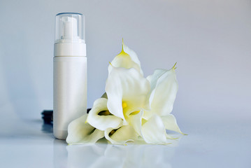 Fototapeta na wymiar Cosmetic product for cream, foam, shampoo. on white background. With white flowers