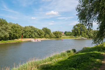 Fototapeta na wymiar Motorboats on river Afgedamde Maas near Woudrichem, Netherlands