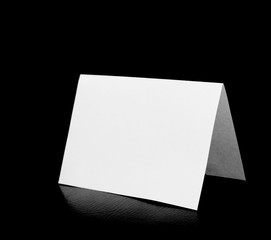 blank folded paper on white
