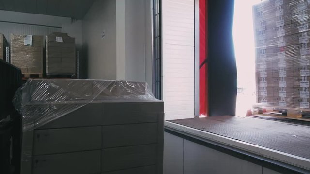 Warehouse worker with a yellow hand pallet truck