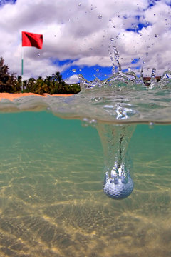 Golf Ball Splash Into Water Near Flag