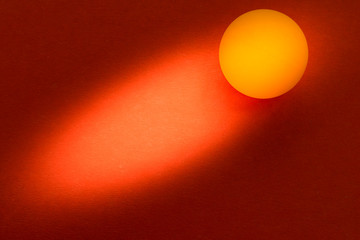 yellow tennis ball on a red background