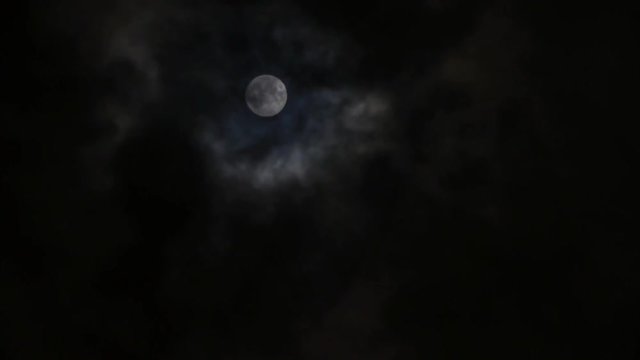 Full moon at cloudy sky,night flight over clouds,time lapse.