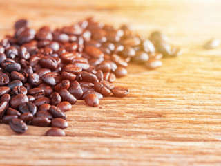 black roasted coffee beans on aged wood