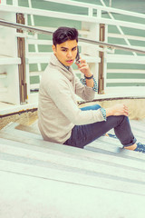 Young Asian American Man talking on cell phone outside in New York