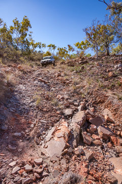 Four wheel drive vehicle attempting to traverse washed out road in the Kimberley Region of Western Australia/
