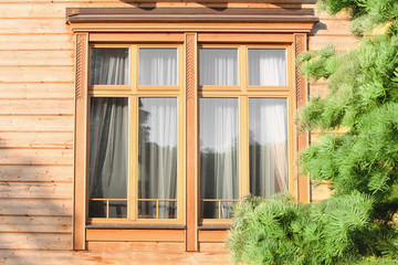 Exterior of building with beautiful wooden windows on sunny day