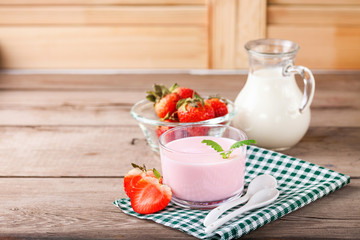 Strawberry yogurt and milk on a table. Selective focus. Copy space