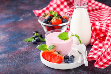 Strawberry yogurt and milk on a table. Selective focus. Copy space