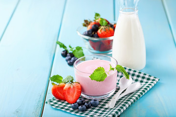 Strawberry yogurt and milk on a table. Selective focus. Copy space
