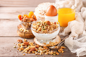 Muesli and yogurt in a glass on a table. Selective focus. Copy space for text