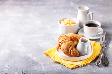 Breakfast - croissant, egg and coffee. Selective focus. Copy space