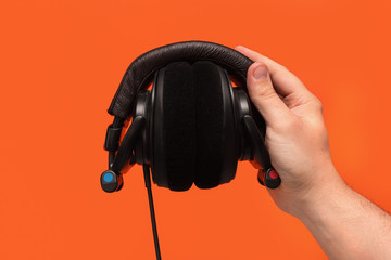 DJ headphones in hand