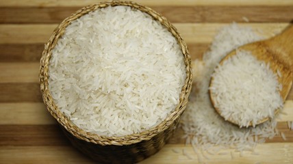 Raw rice on wooden table