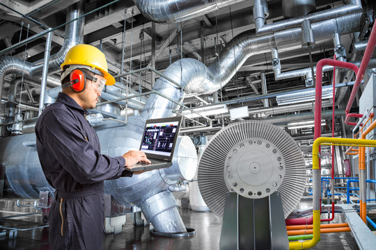 Engineer using laptop computer for maintenance in thermal power plant factory