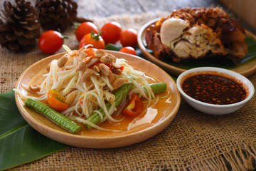 Papaya salad with fried chicken and vegetables, Som Tum, Traditional Thai food.