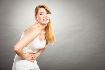 Woman suffer from belly pain.