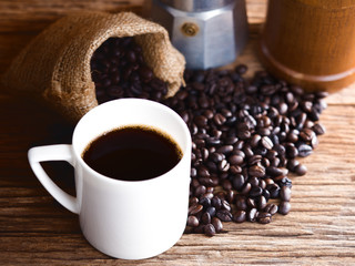 black roasted coffee beans on aged wood