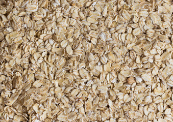 Top view oat flakes or oatmeals for background and texture. Rolled oat is clean food for health lover people. Prepare oat flakes for bakery or cooking. Natural organic food in natural style concept.