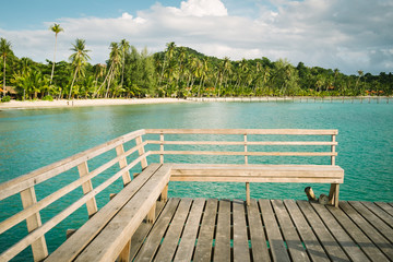 Wooden lounge chairs sitting on the deck of an overwater