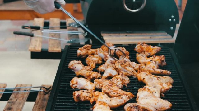 Barbecue With Delicious Grilled Meat On Grill. Barbecue Party. Chicken meat pieces being fried on charcoal grill .Cooking delicious juicy meat steaks on the grill on fire.