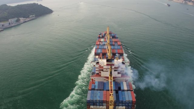 Hong Kong Aerial v37 Flying low around large cargo ship passing by.