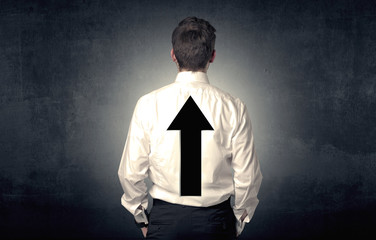 Young businessman standing with arrow on his back