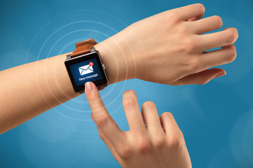 Hand with smartwatch and blue background