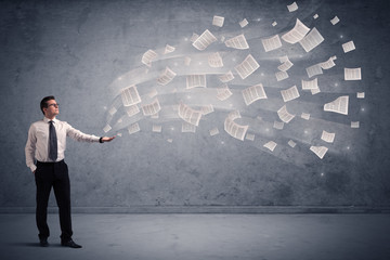 Caucasian businessman holding newspapers