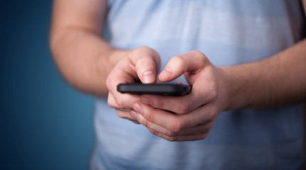 Young man holding smarthphone in hand