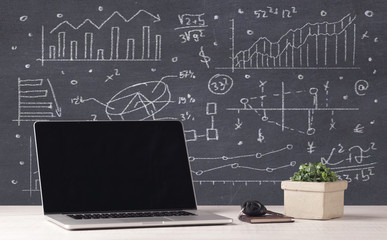 Financial business charts and office laptop