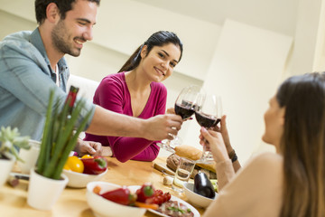 Young people have a meal in the dining room in modern home
