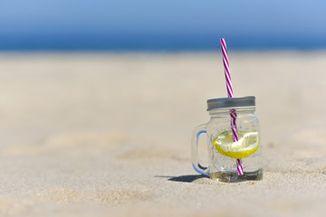 Lukecin, Poland, June 15, 2017: Cold drink in jar on the beach with copy space.