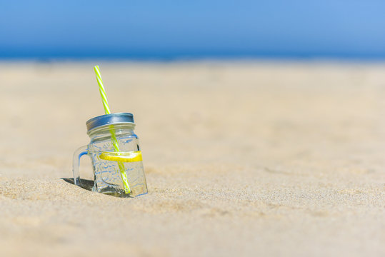 Lukecin, Poland, June 15, 2017: Cold drink in jar on the beach with copy space.