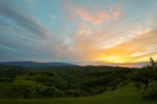 Evening and sunset on mountain hills of a romanian village © brszattila