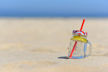 Cold drink in jar on the beachwith copy space.