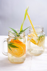 Water with orange, lemon and mint leaves