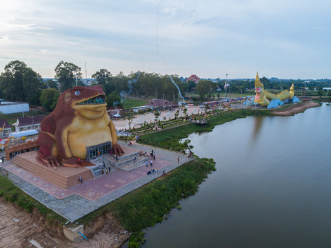 Drone camera : Statue of Naka and Toad king MUSEUM - Public Landmark beside the river with a blue sky and cloud in Yasothon, Thailand. (Pha Ya Kan Kark or Toad King statue)