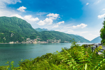 Fototapeta na wymiar Lake Lugano, Campione d'Italia, Italy. View of the small town of Campione d'Italia, famous for its casino, and Lake Lugano from Switzerland on a beautiful summer day