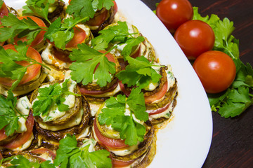 Juicy fried zucchini in garlic sauce with herbs.