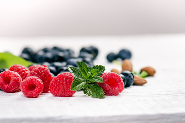 Fresh blueberries with mint on a wooden white table. Natural antioxidant. Concept of healthy food. Organic superfood
