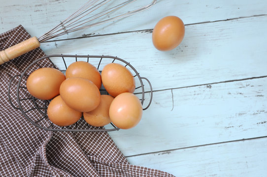 Top View of Eggs in Basket with Whisk
