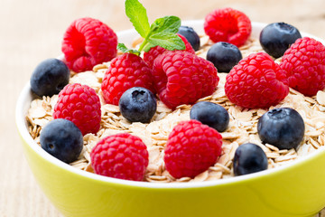 Oatmeal porridge with berries. Raspberries and blueberries.