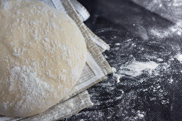 Dough Flour on black table. Сulinary Сoncept