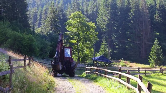 Old red truck driving on rural road in beautiful scenic landscape. Real time full hd video footage.