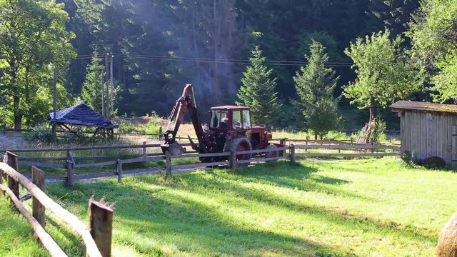 Old red truck driving on rural road in beautiful scenic landscape. Real time full hd video footage.