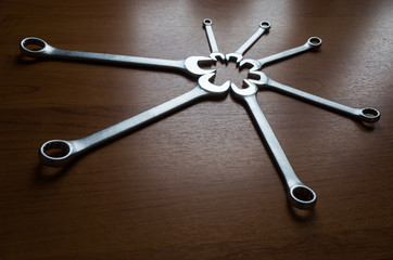 Set of metal wrenches on a wooden background.